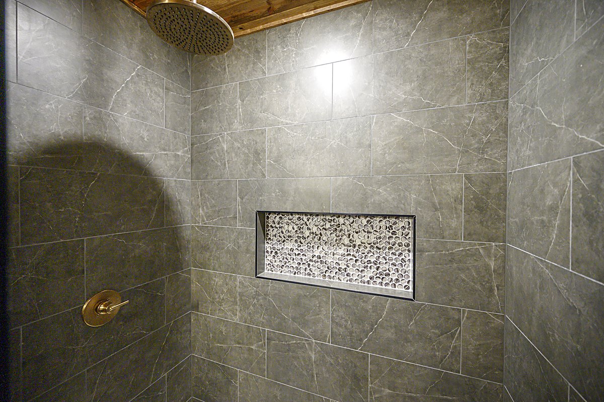 Rain shower head and tiled niche, up close