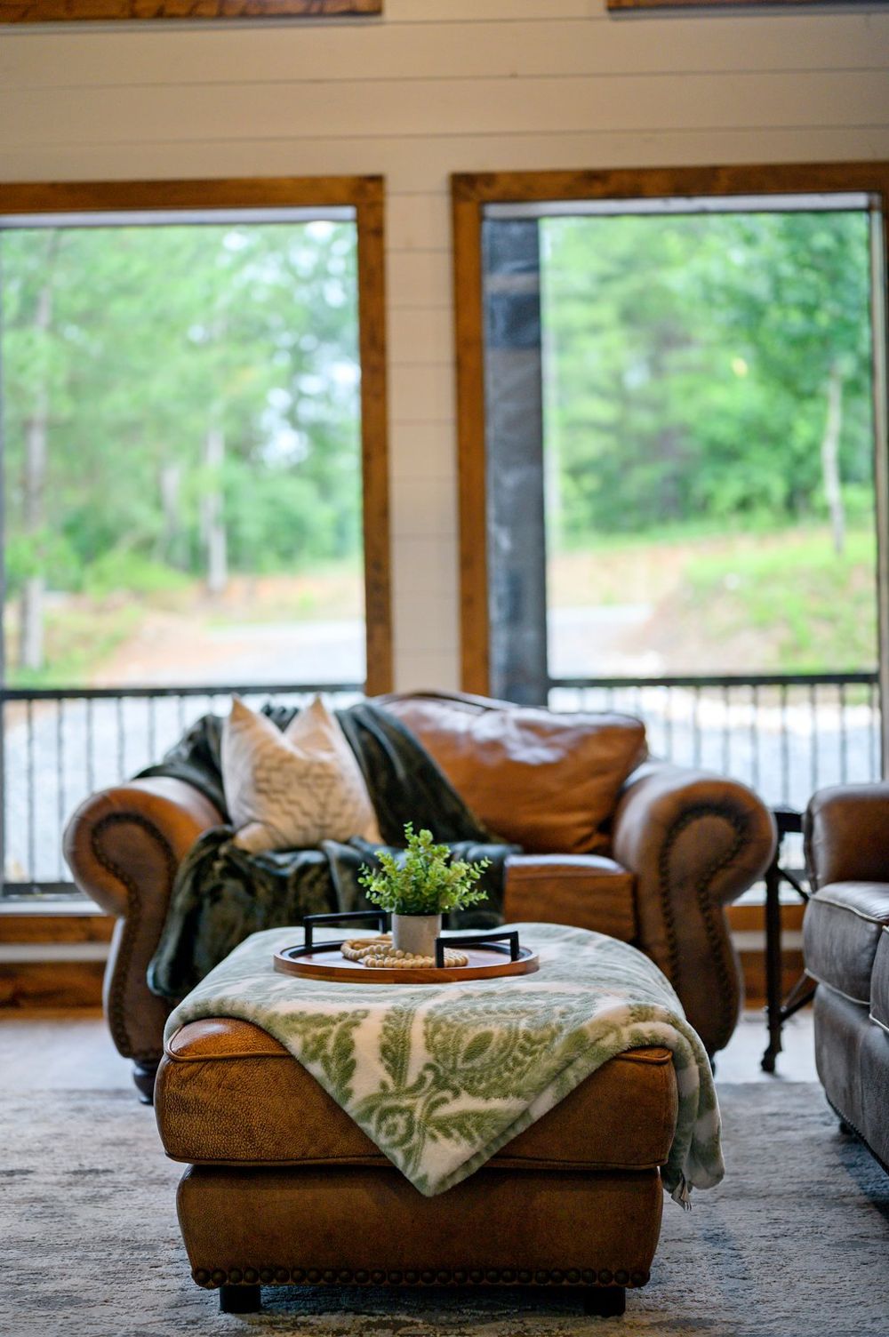 Leather chairs by the picture windows