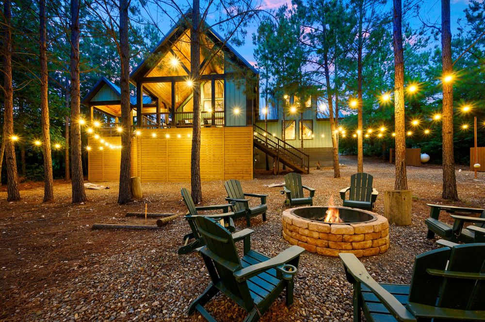 Fire pit circle at dusk with string lights