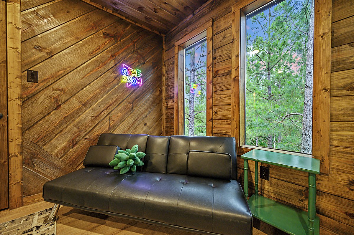 Game room futon lounge with neon sign