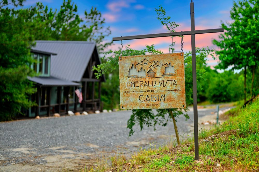 The Emerald Vista Cabin sign at the driveway